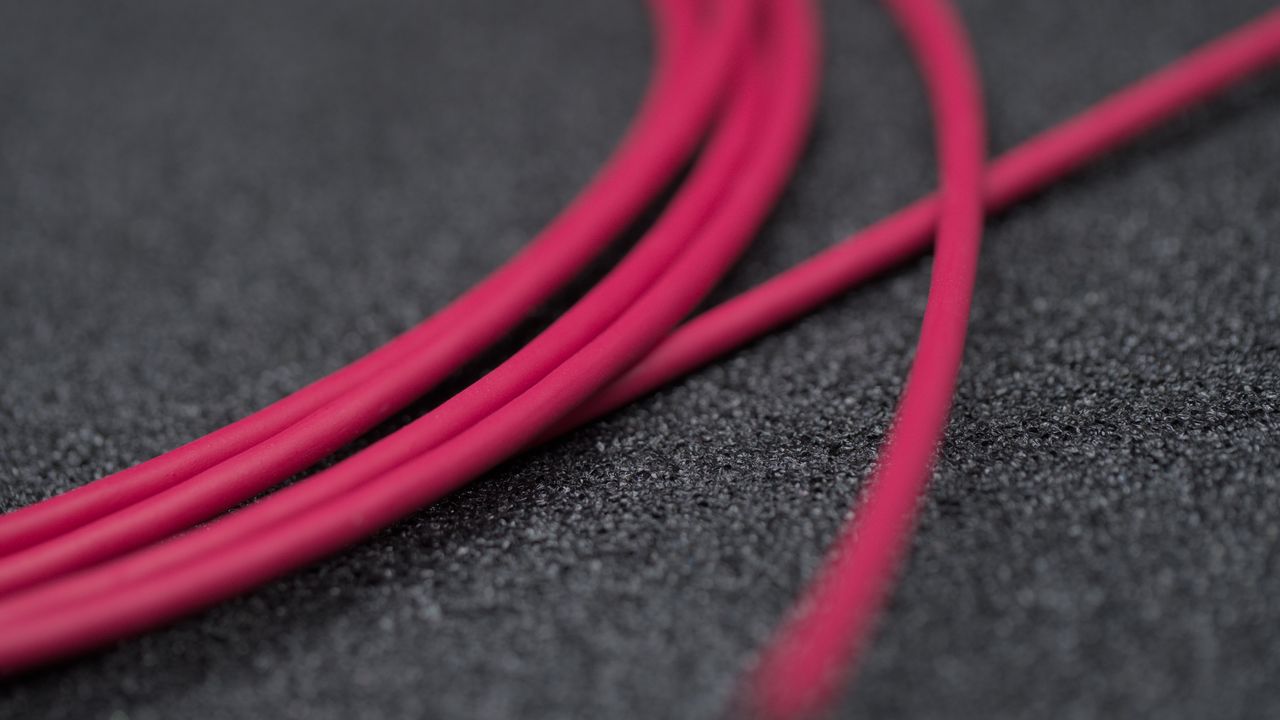 A rolled up M2S cable, showcasing the red PUR jacket.