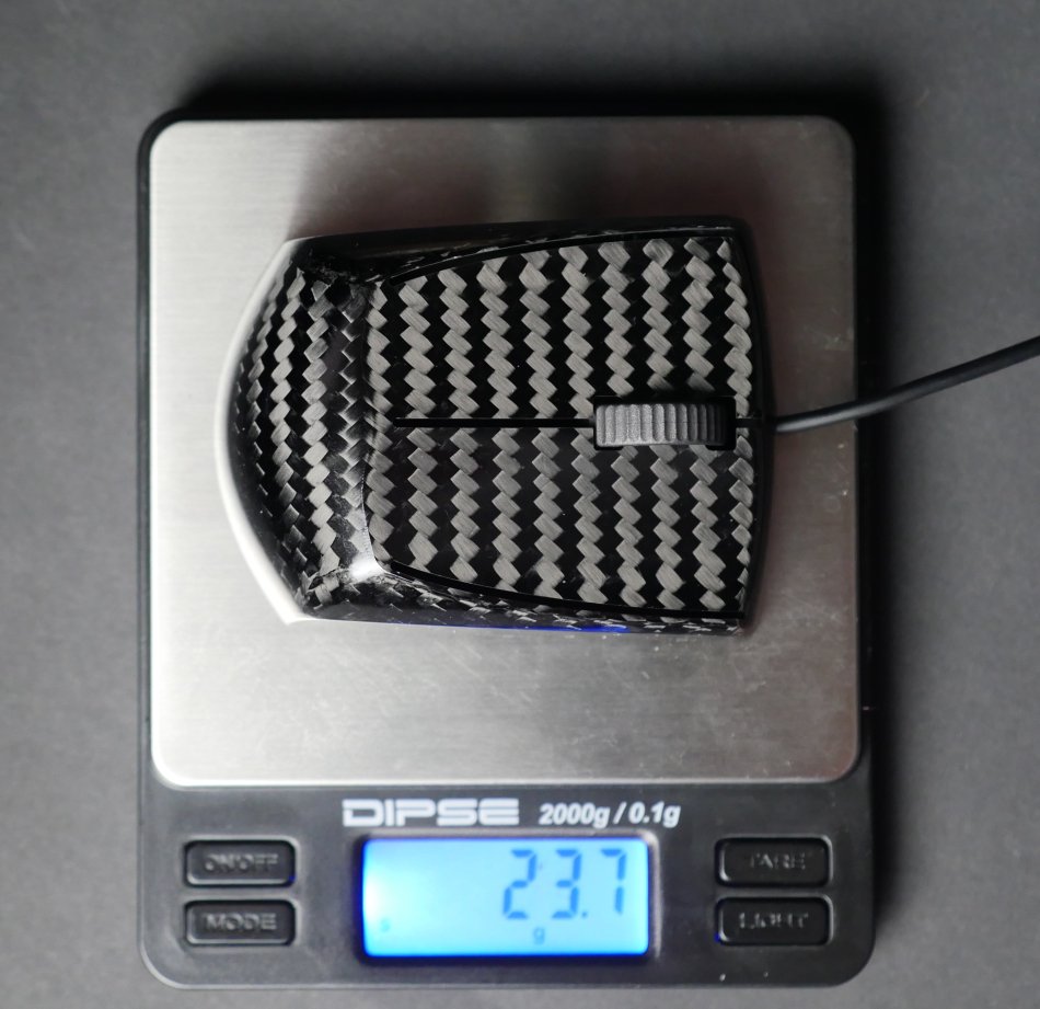 This picture shows the Zaunkoenig M2K sitting on a scale. The M2K weighs in at just 24 grams, making it the worlds lightest gaming mouse in production.